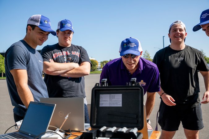 Jeff Freedman and students review weather balloon data in real time from the ETEC parking lot.