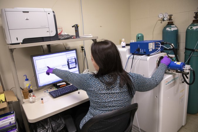 Allix Coon uses a mass spectrometer to chemically analyze a wood sample.