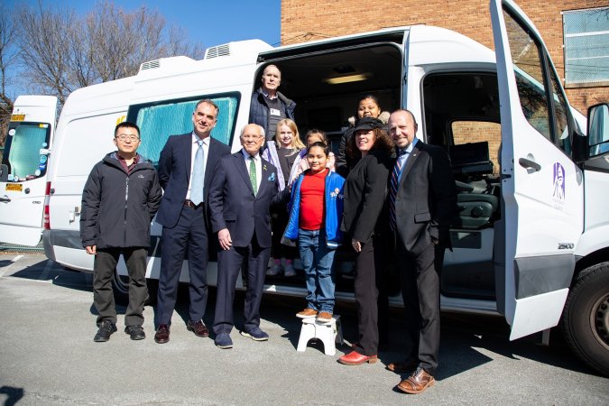 Students at Giffen Memorial Elementary School stand with Congressman Tonko, UAlbany researchers and other officials in front of a mobile laboratory.