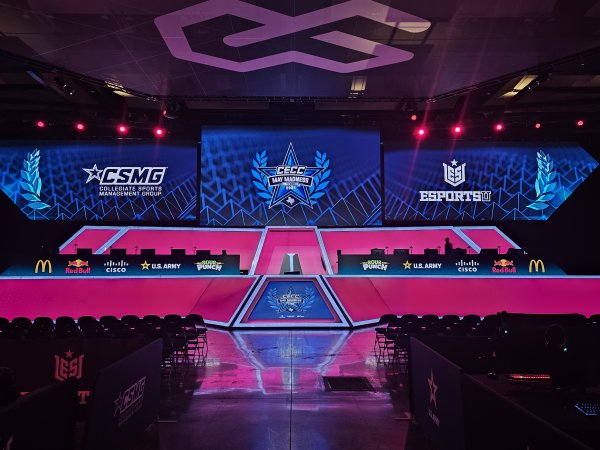 The main stage at the Esports Stadium Arlington lit up in pink and blue lights.