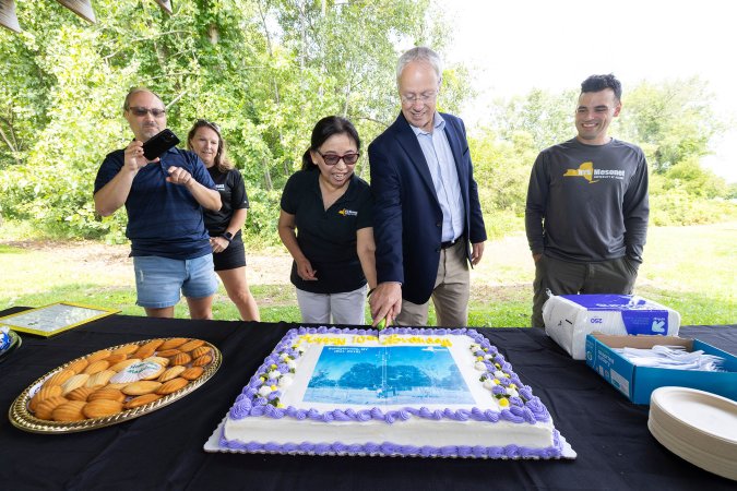 Mesonet leaders cut a cake to celebrate the Schuylerville site's 10th birthday.
