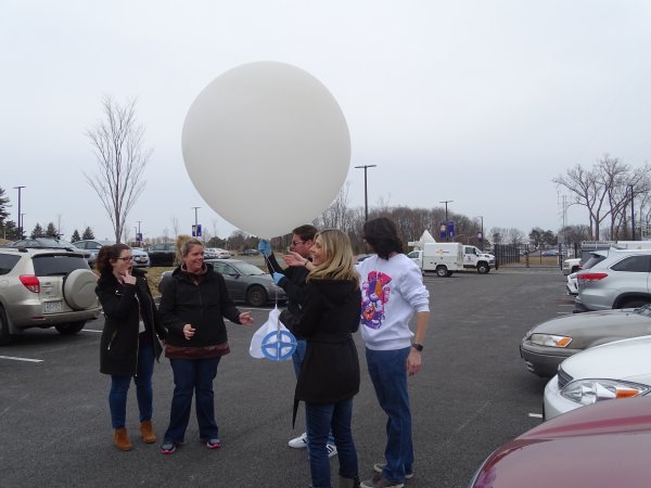 North Colonie elementary teachers and UAlbany student interns prepare a weather balloon for lift off at the ETEC parking lot.