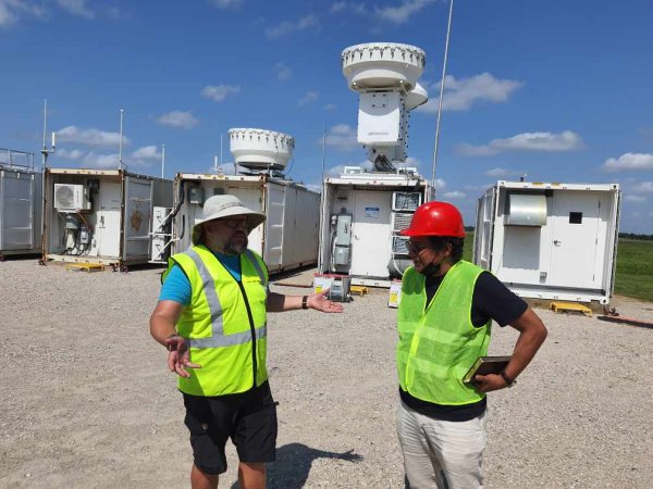 González-Cruz and research colleague Scott Collis wear hard hats at the U.S. Department of Energy facilities.