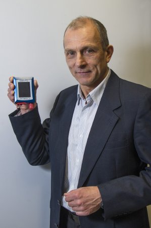 Chemist Igor Lednev holds a portable Raman spectrometer.