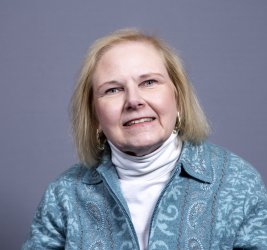 Dr. Dewar smiles at the camera.