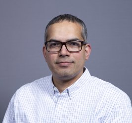 Dr. Banavali smiles at the camera.