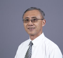 Dr. Shijun Lu smiles at the camera.