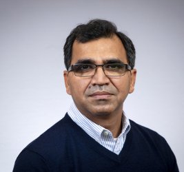 Anil looks at the camera.