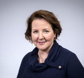 Kirsten smiles at the camera.