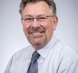 Patrick smiles at the camera.