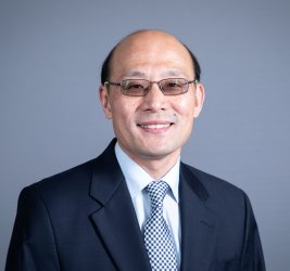 Liang Chu smiles at the camera.