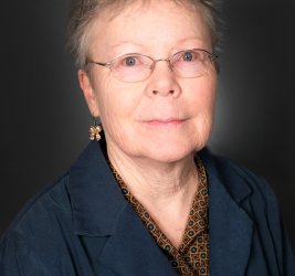 Millicent smiles at the camera.