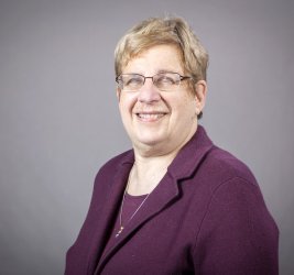 Dr. M. Dolores Cimini headshot wearing purple blazer