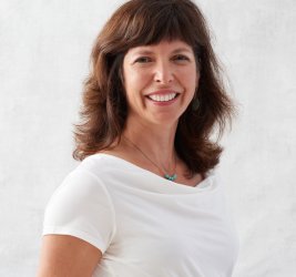 Dr. Deborah Schussler smiling brown hair white shirt white background