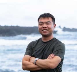 Chong Liu standing before ocean