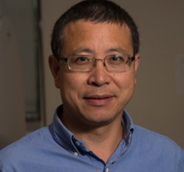 Qishan Lin in a blue button up and glasses