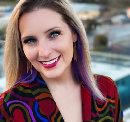 Dr. Melanie Wilcox smiling outside in colorful jacket
