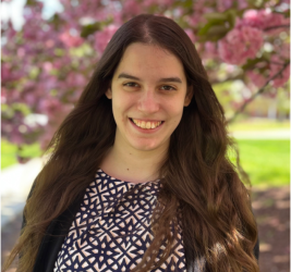 Dr. Mary DePascale smiling in front a flowering tree outside