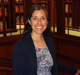 Dr. Kristie Asaro-Saddler smiling in library