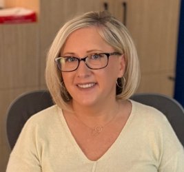 individual with glasses and blonde hair smiling