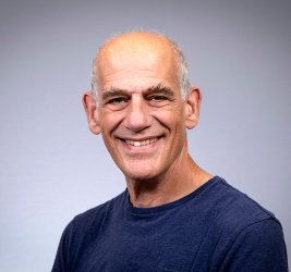 William smiles at the camera.