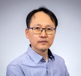 Bum Kyu smiles at the camera.