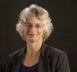 Dr. Heidi L. Andrade smiling with black background