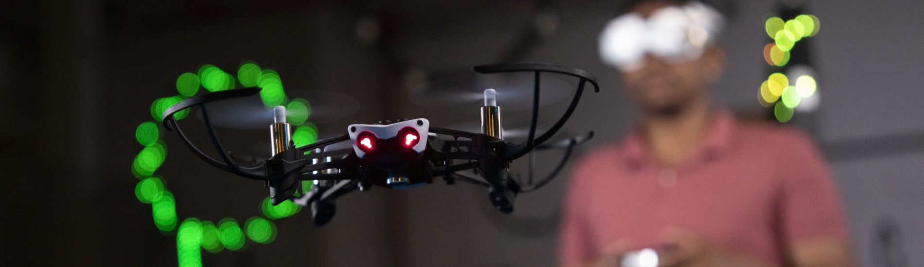 Student wearing a virtual reality headset controlling a flying drone.
