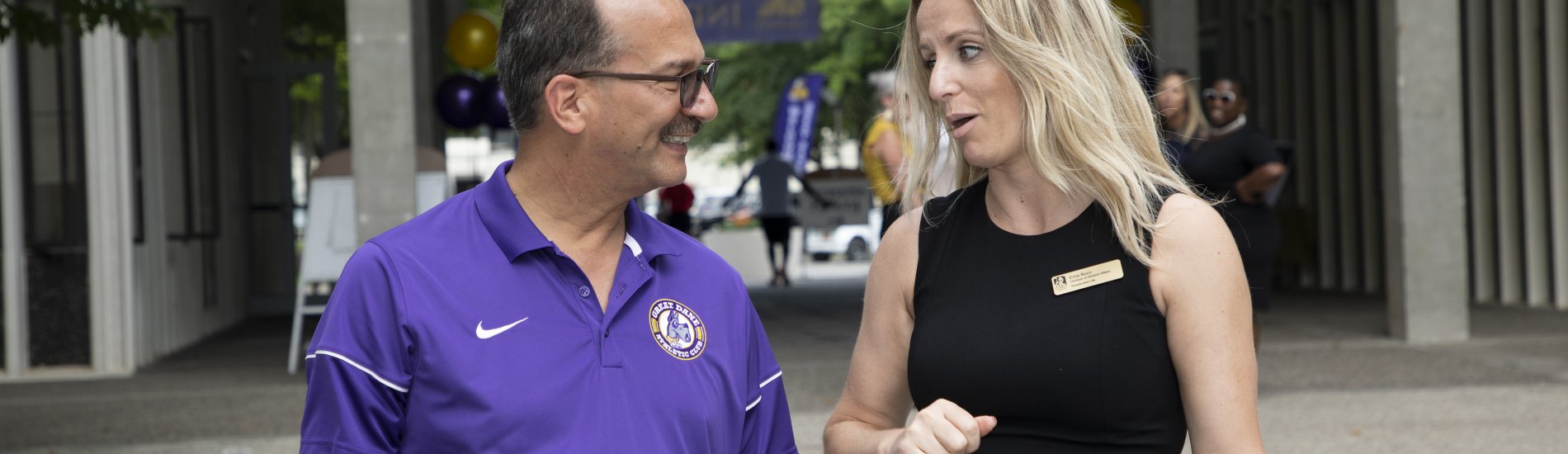 Ema Buco, Assistant Director for Residential Life, speaks with the UAlbany President outside Indigenous Quad on a move-in day