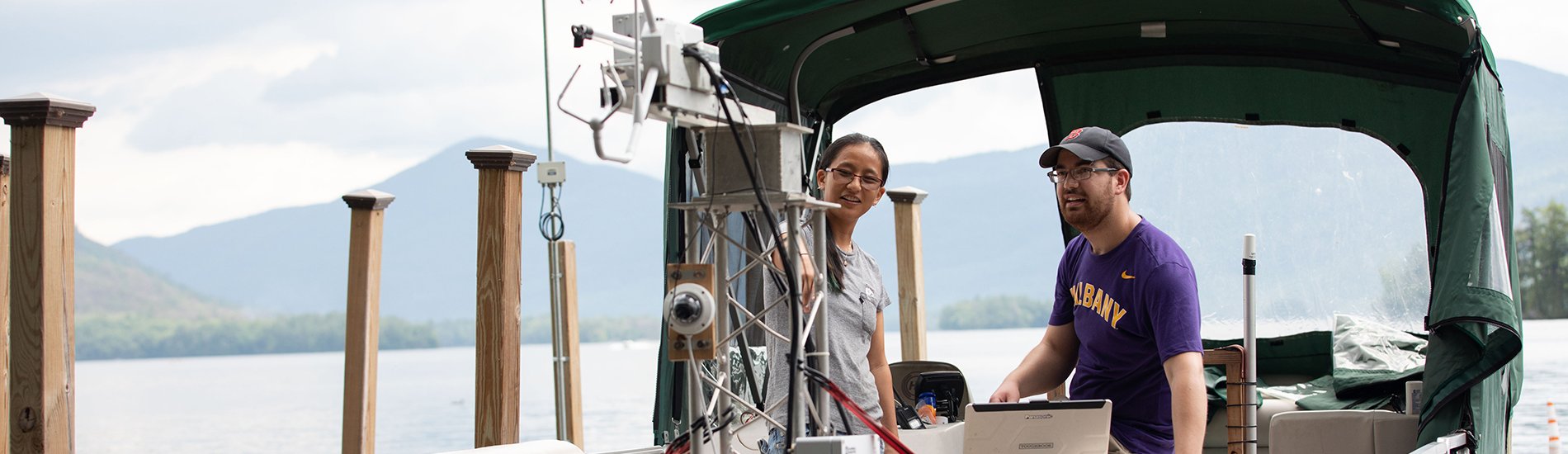 Students of the Atmospheric Sciences Research Center (ASRC), funded through $500,000 in support from the Department of Energy (DOE), works on a buoy-based flux measurement system at Lake George on Wednesday, June 30, 2021. (photo by Patrick Dodson)