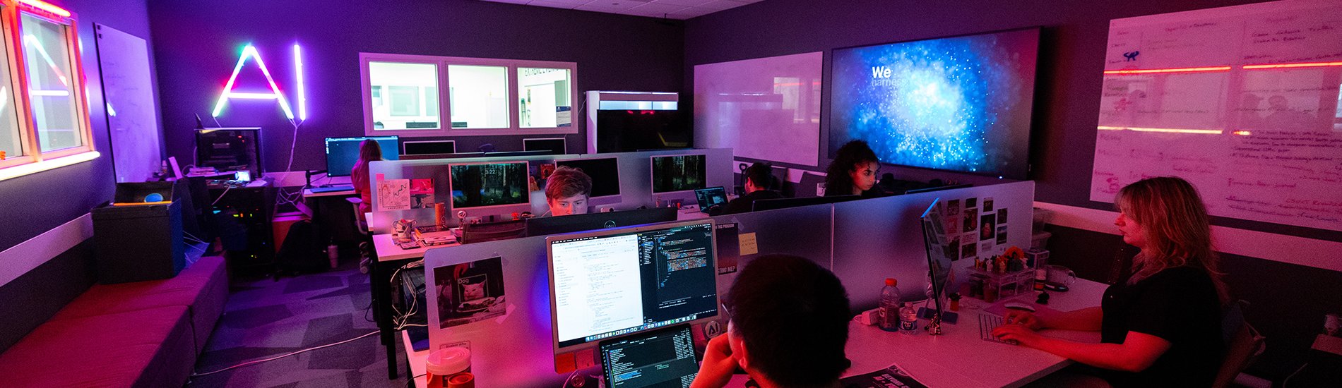 A group of students working on computers in UAlbany's AI lab.