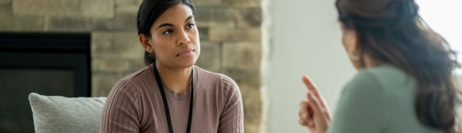 A smiling counselor meets with a client.