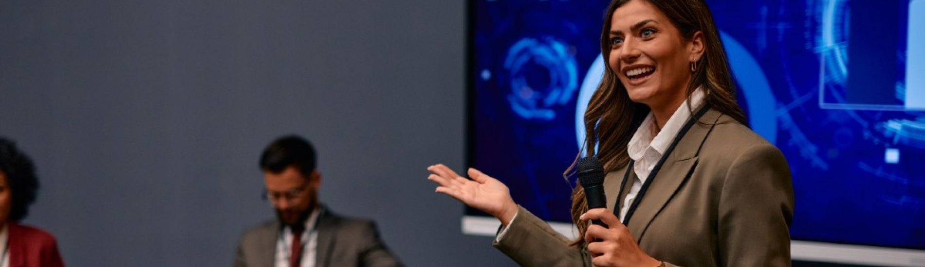 A public relations specialist answers questions at a press conference.