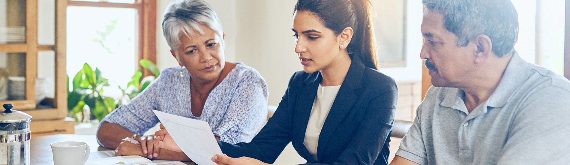 A mature couple getting advice from their financial consultant at home.