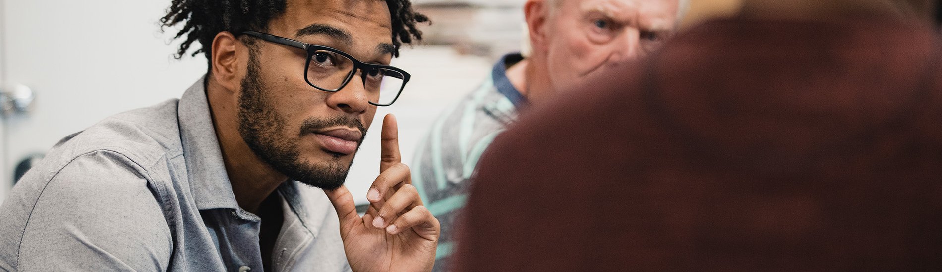 A group of people sitting in a support group session.