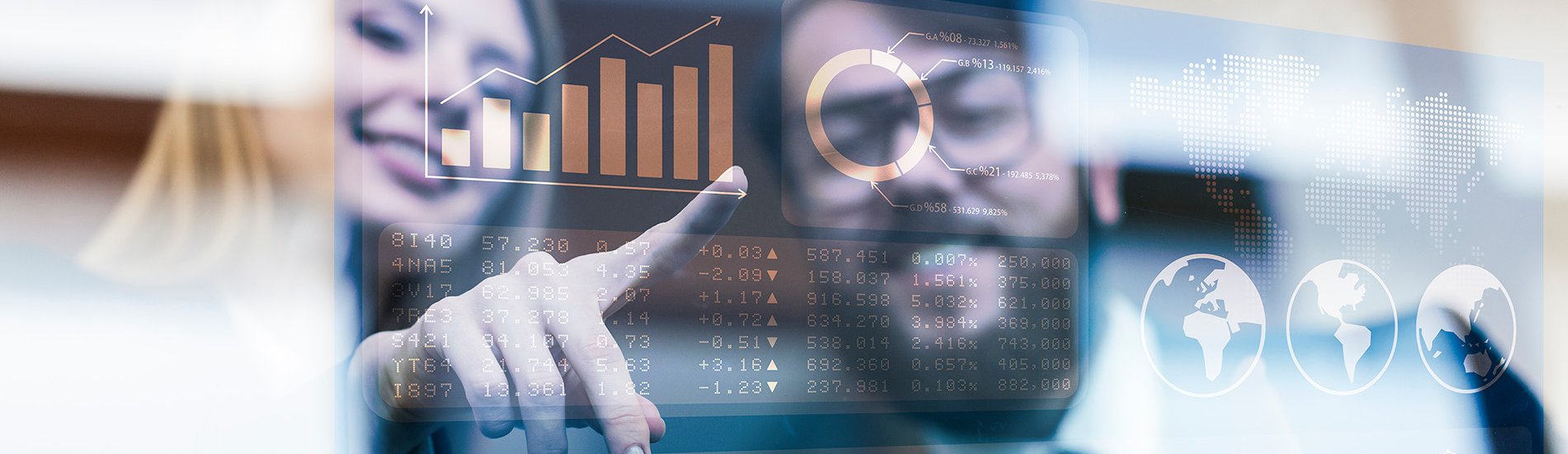 Two professionals looking at stock market graphs.