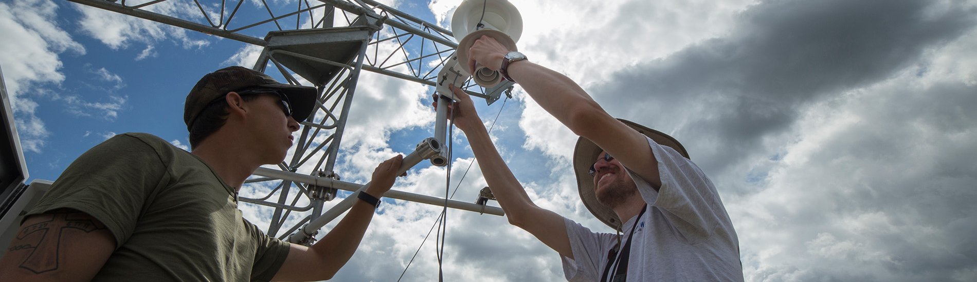 Two UAlbany researchers working on a New York State Mesonet tower.