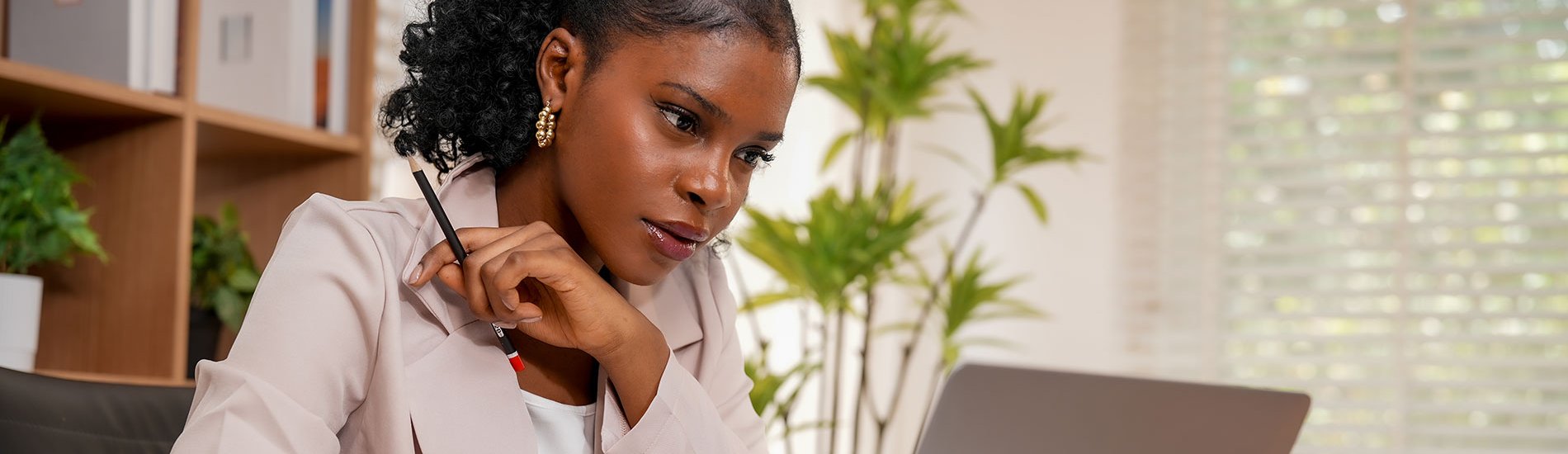 A sociologist reviews research on her laptop.
