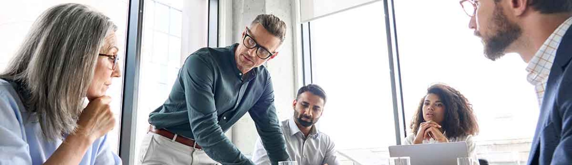 A digital marketing team meets around a conference table.