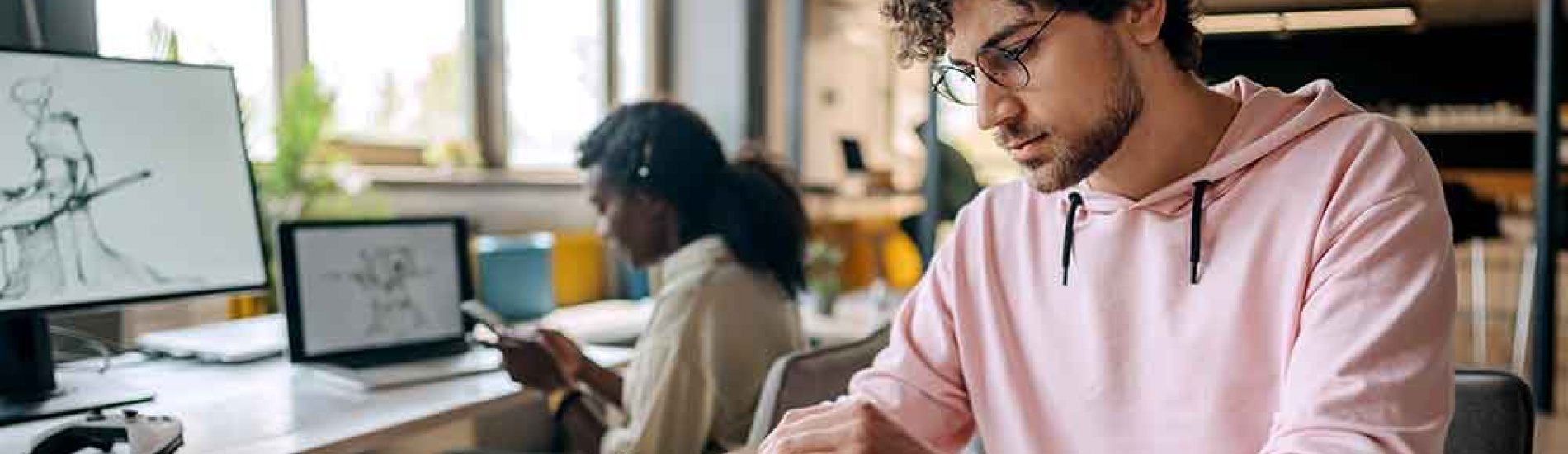 Video game designers work on a new game in a shared office space.