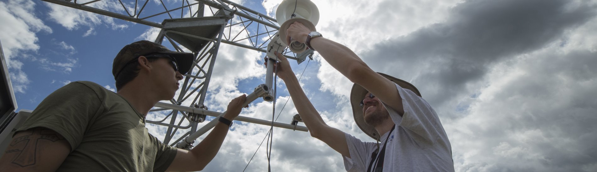 Two UAlbany researchers working on a New York State Mesonet tower.