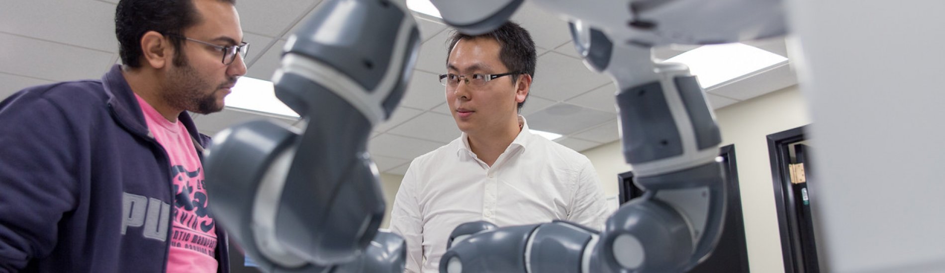 Researchers work on robotic arms