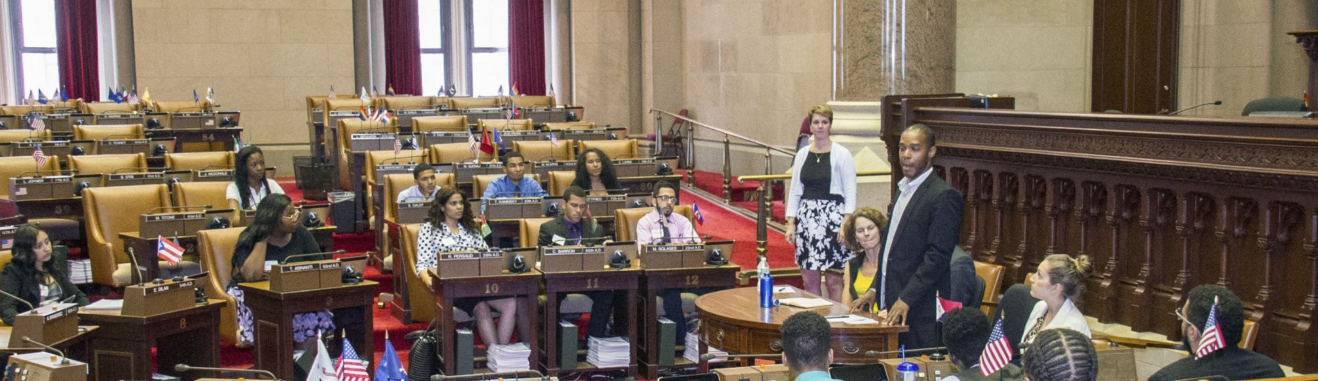A group of students participating in a mock legislative session inside the New York State Capitol building.