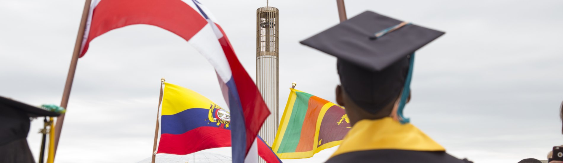 International students carry flags at Commencement.