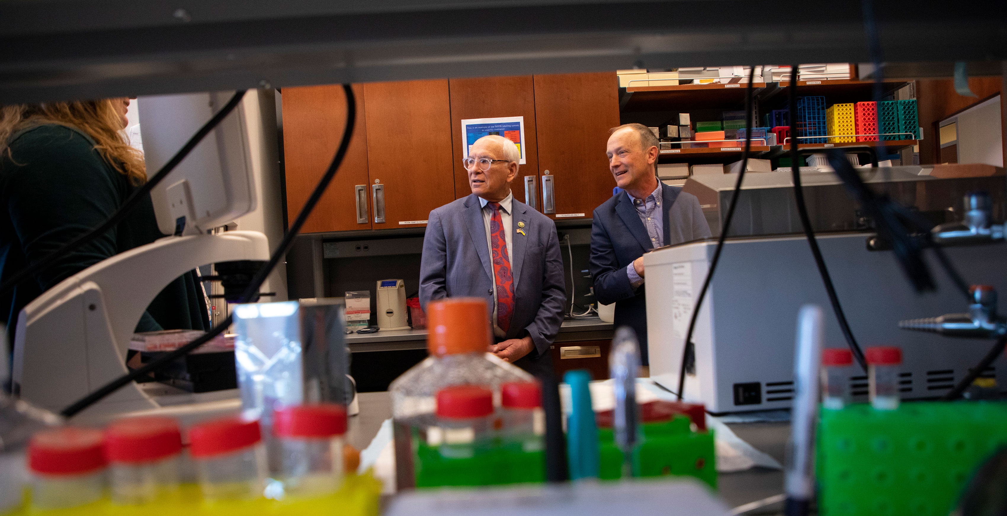 Representative Paul D. Tonko stands inside a laboratory with a UAlbany researcher.