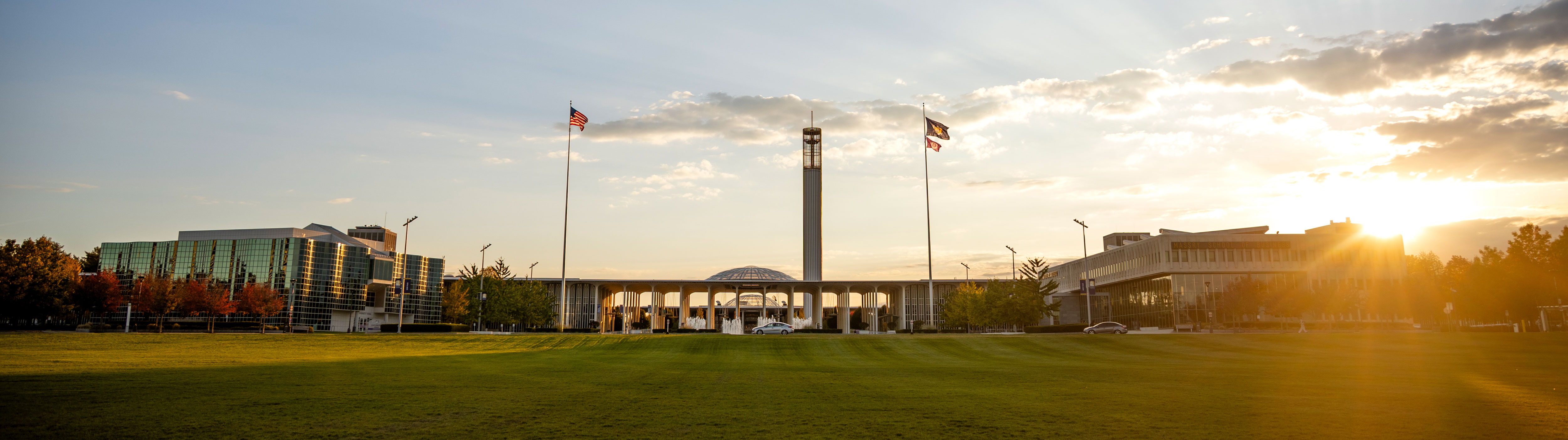 The sun sets behind UAlbany's Academic Podium, as photographed from Collins Circle on an early fall evening.