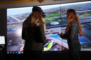 Kara Sulia and Vanessa Przybylo use a VR headset in the xCITE lab to explore views from the top of the Carillion on the Uptown Campus.