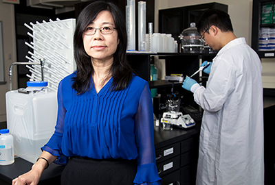 ESE Professor and Chair Yanna Liang stands in front of her lab.