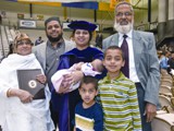 A new Ph.D. poses with her family after the ceremony.