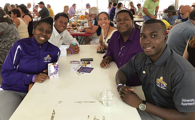 Alumni pose for a picture at the Saratago Race Course